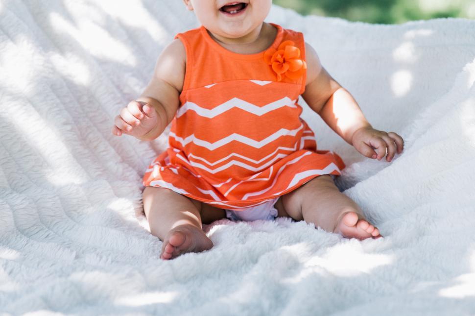 Free Image of A caucasian baby girl sitting outdoors 