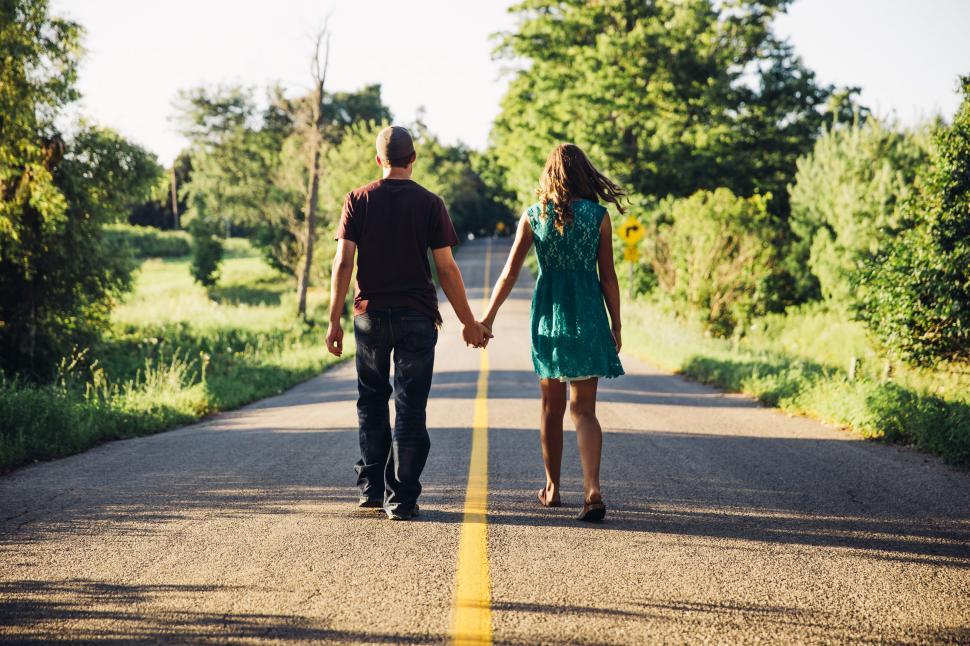 Free Image of A young caucasian couple holding each other s hands 