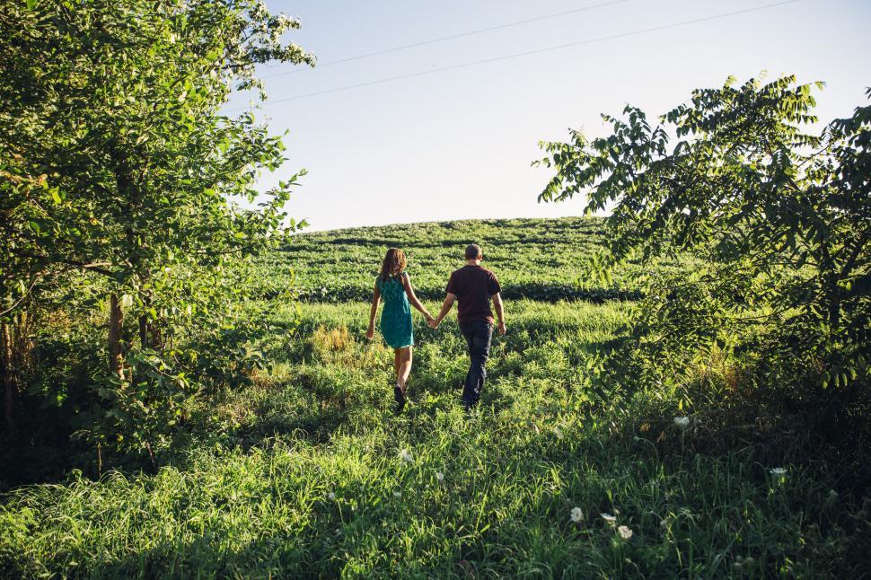 Free Image of A young caucasian couple holding each other s hands 