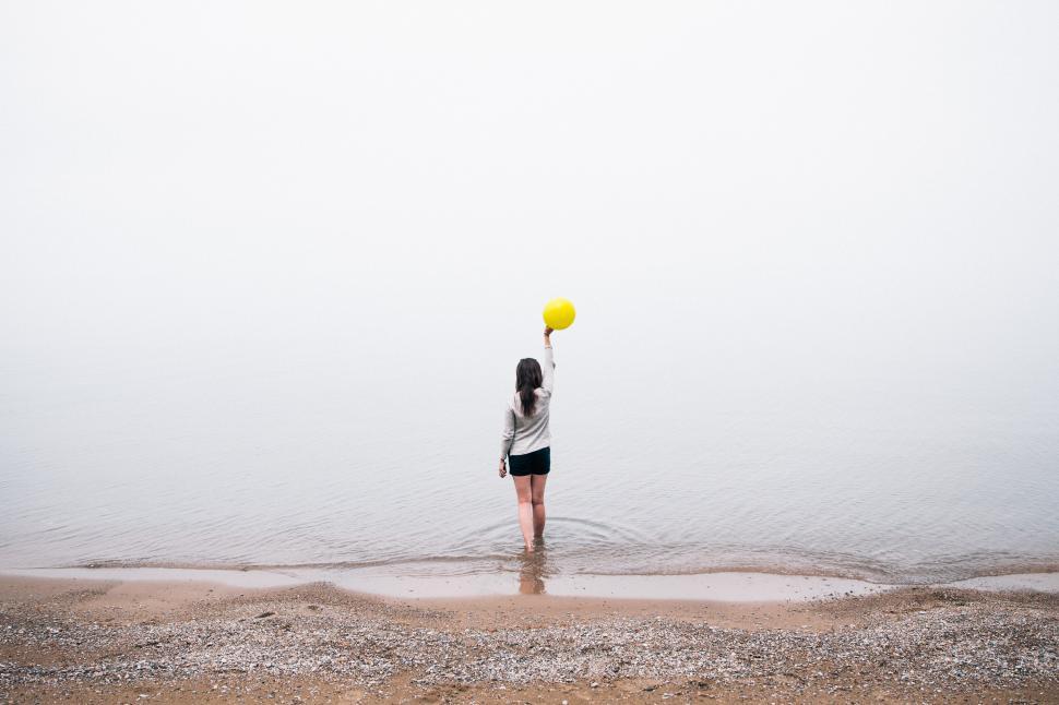 Free Image of A young brunette holding a balloon 