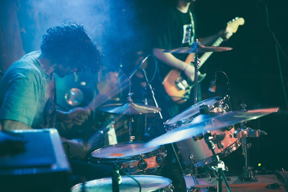 Free Image of A drummer playing along with a guitarist in a concert 
