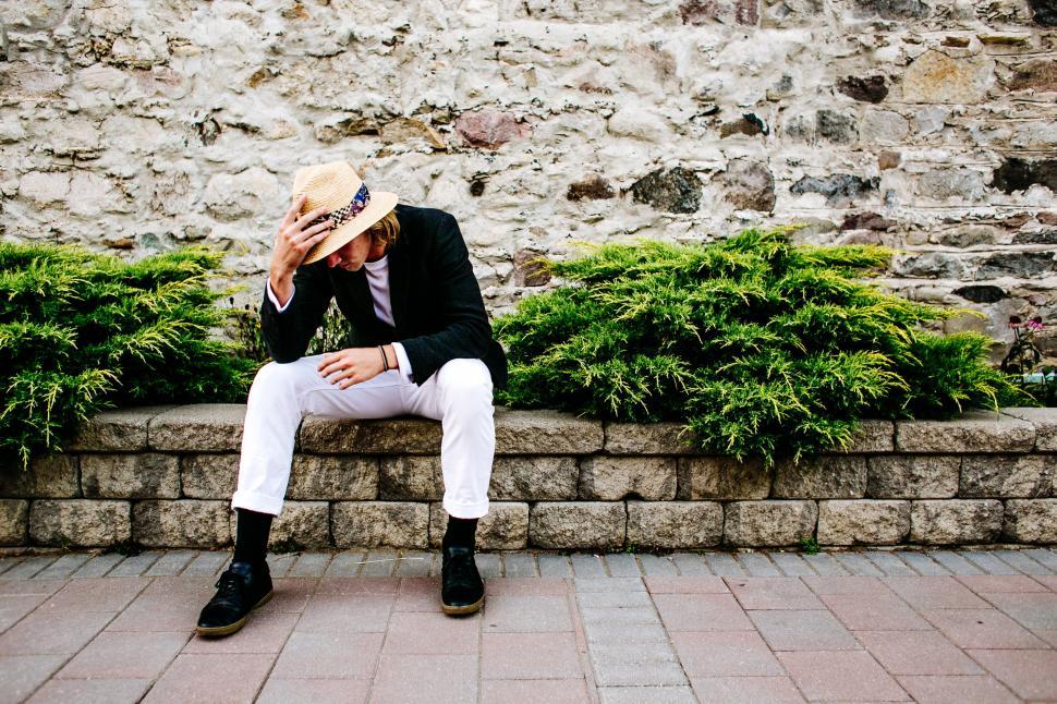 Free Image of A young caucasian man wearing hat posing outdoors 