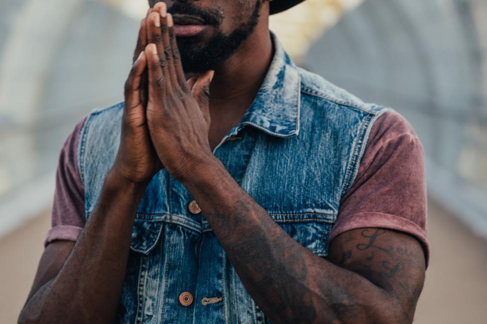 Free Image of A young African American man with folded hands 
