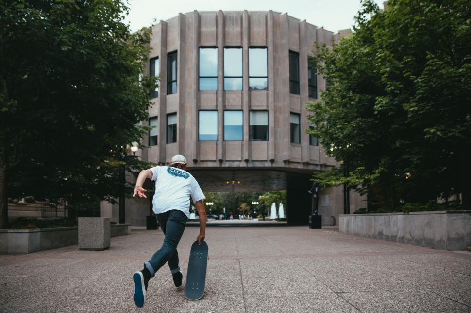 Free Image of A young caucasian skateboarder taking a start 