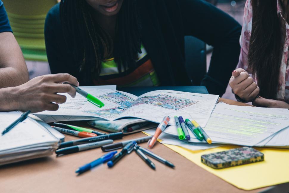 Free Image of A group of multiethnic students working on project 