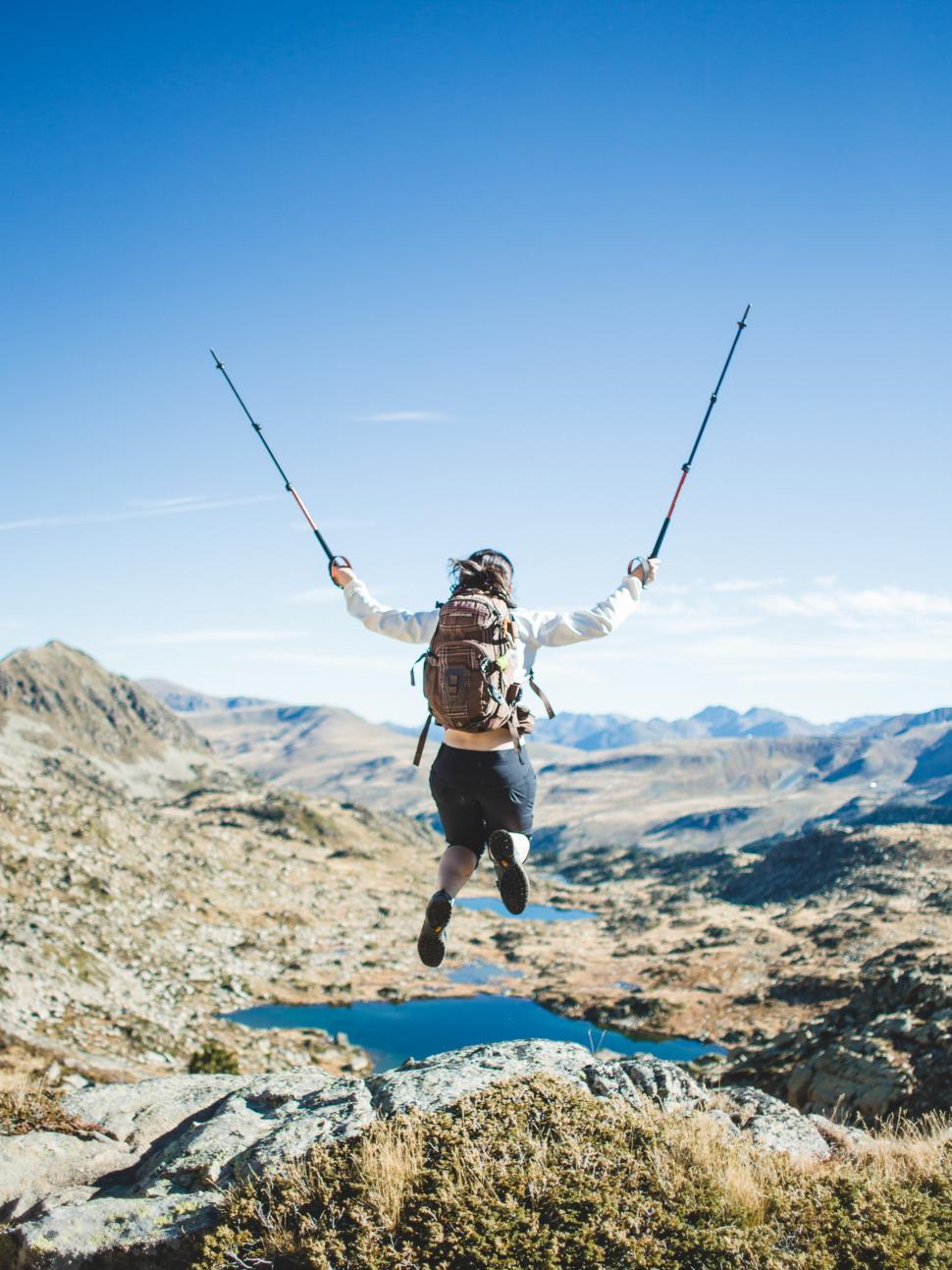 Free Image of A hiker jumps in joy 