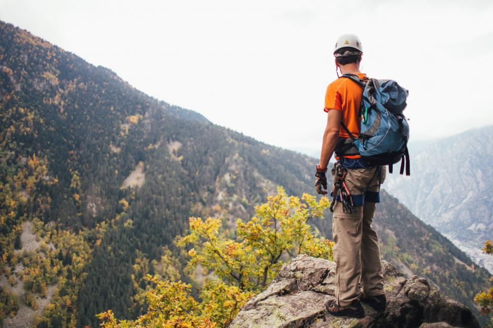 Free Image of A young climber standing on a rock 