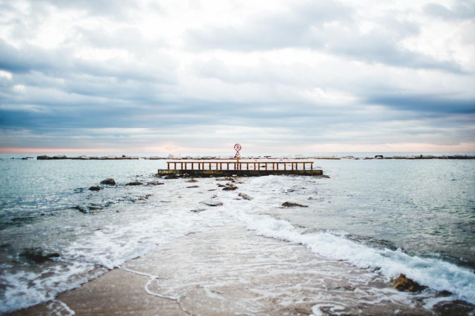 Free Image of Ocean under cloudy sky at sunset 