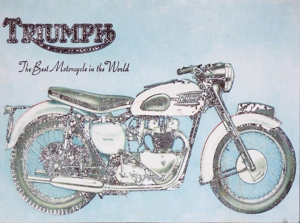 Free Image of Vintage aged advertising sign board for the Triumph motorcycle brand  