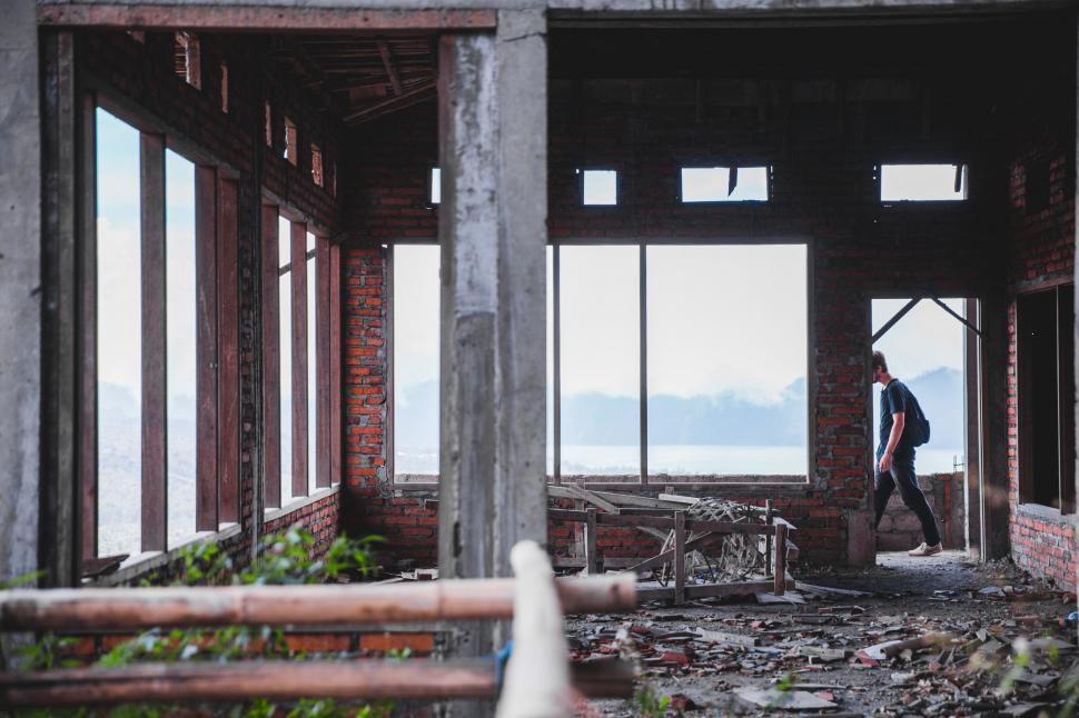 Free Image of A young man walking on the balcony of an under-constru 