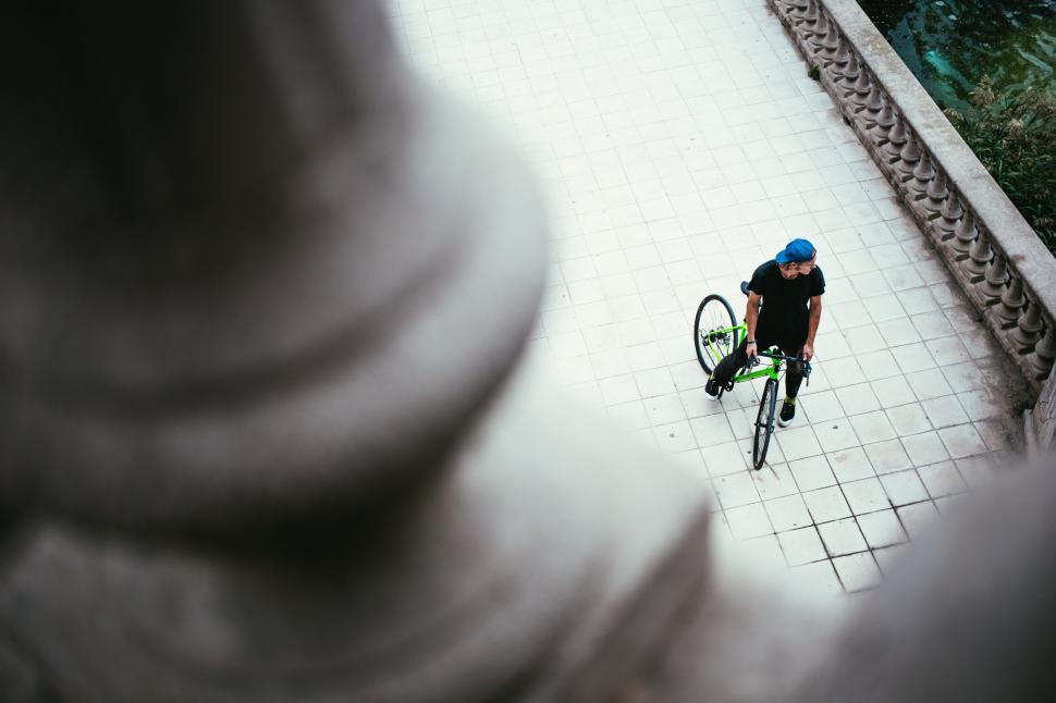 Free Image of A young Caucasian male cyclist halts on the street 