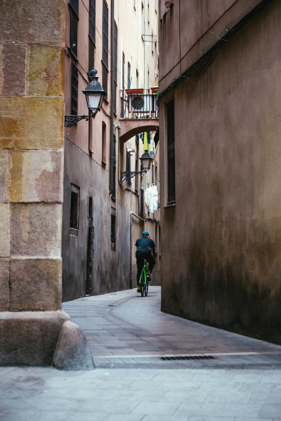 Free Image of Cycling down a narrow alley 