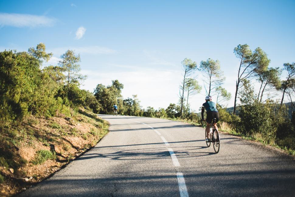 Free Image of Country road cyclist on a curvy road 