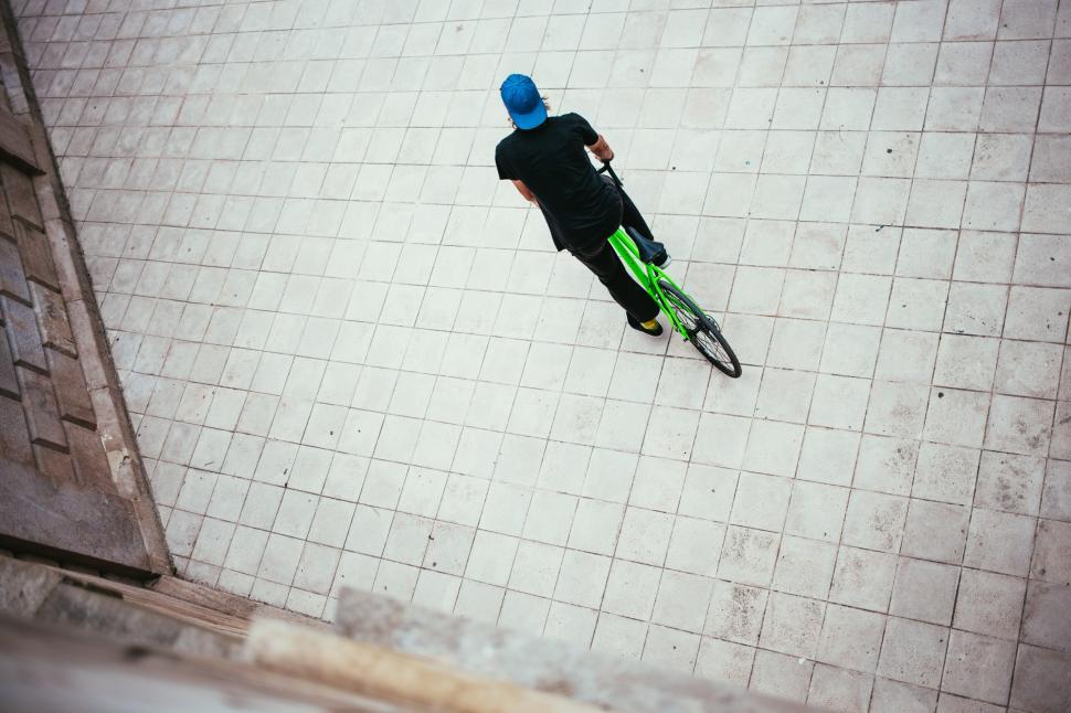 Free Image of A young Caucasian male cyclist halts on the street 