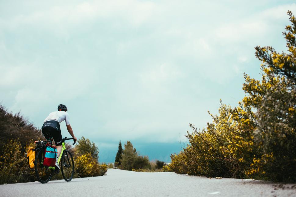 Free Image of Country road cyclist on a curvy road 