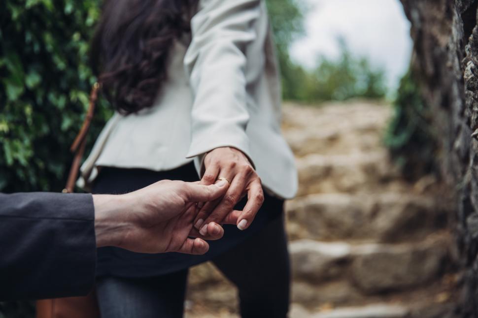 Free Image of A young caucasian couple holding each other s hands 