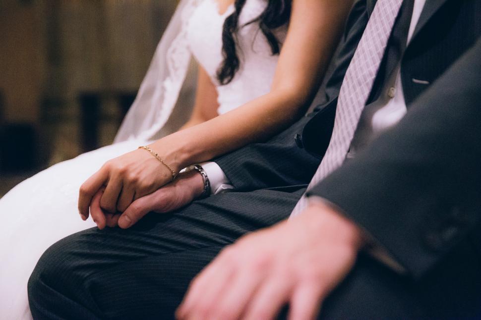 Free Image of Bride and groom holding each other s hand 