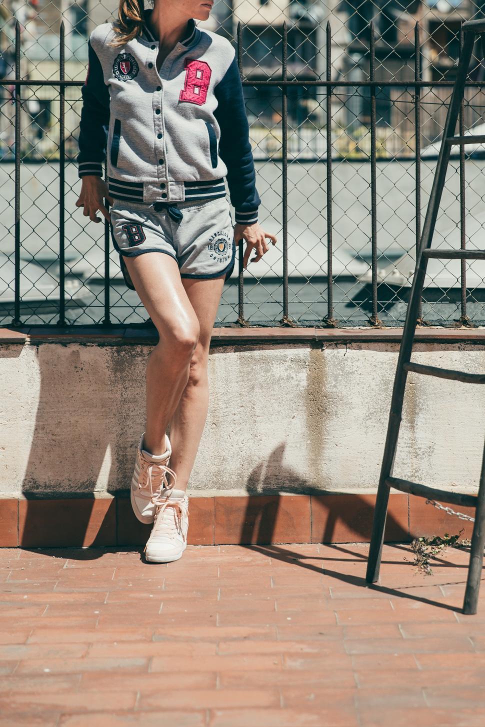 Free Image of A young blonde woman in casuals posing outdoors 