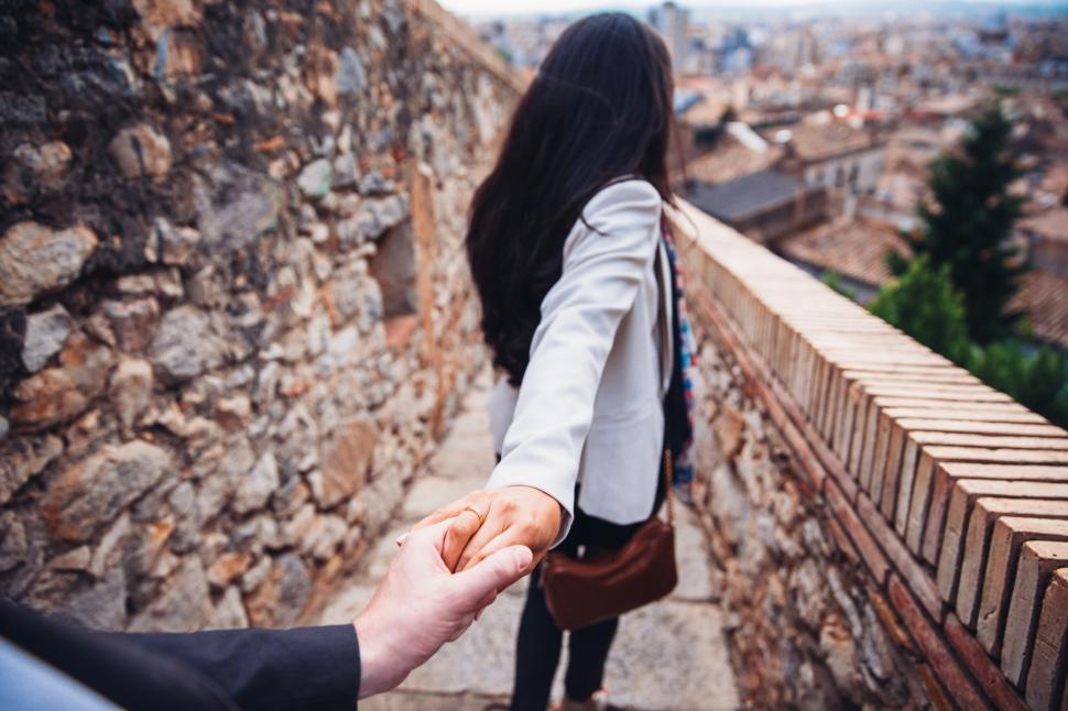 Free Image of A young Caucasian couple with woman leading while holding man s 