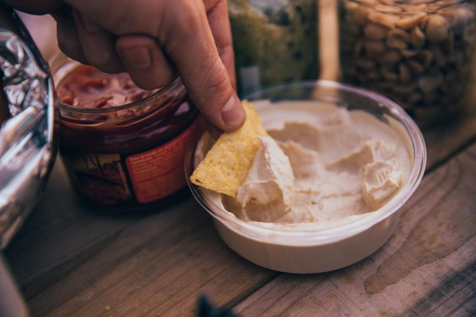 Free Image of Dipping Tortilla chip in Hummus 