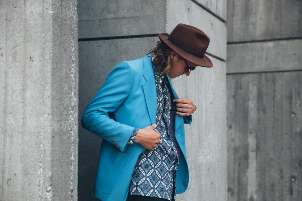Free Image of A young caucasian man wearing turquoise blue jacket posing outdo 