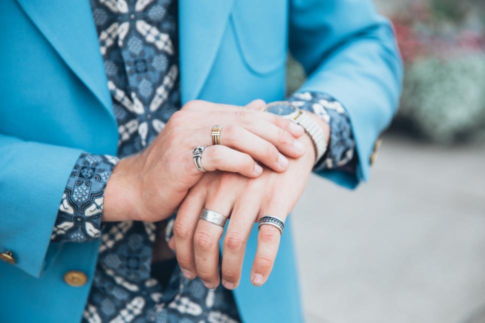 Free Image of A young caucasian man wearing turquoise blue jacket checking tim 