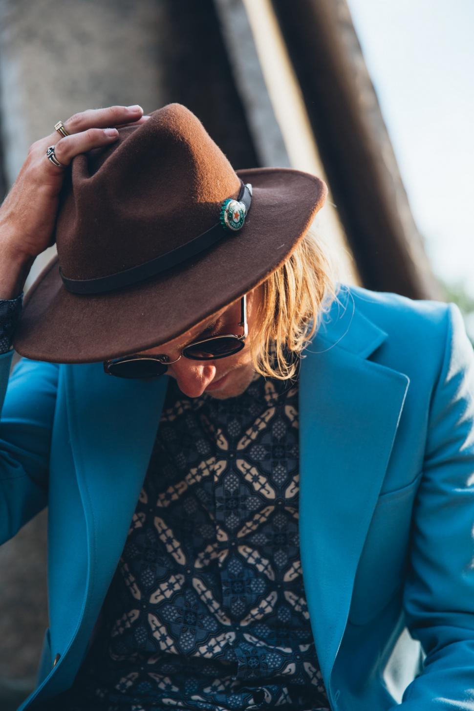 Free Image of A young Caucasian man wearing turquoise blue jacket posing outdo 