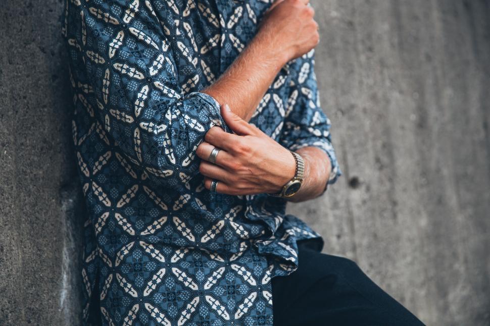 Free Image of A young caucasian man wearing patterned shirt posing outdoors 