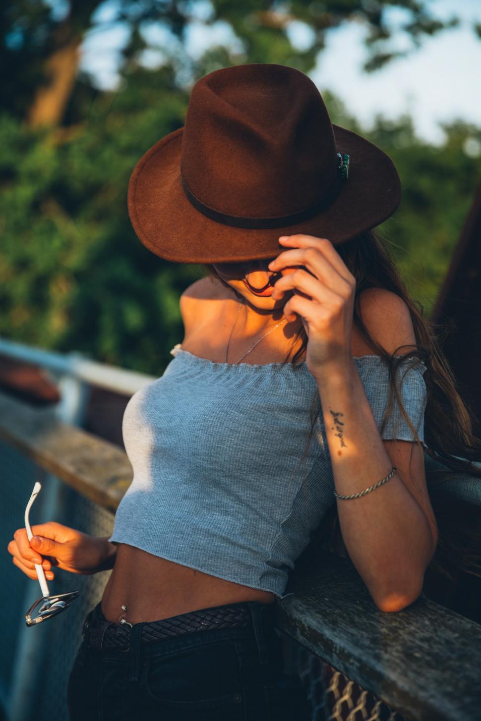 Free Image of A young Caucasian woman smiling at sunset 