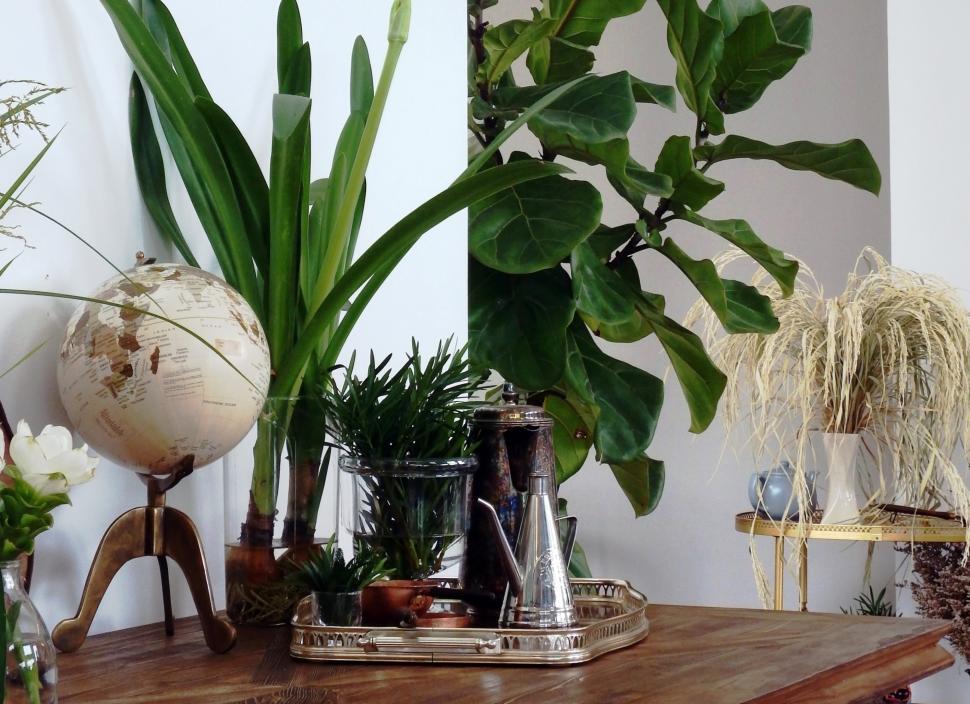Free Image of Interior design details A globe and silver tea set in a dining room  