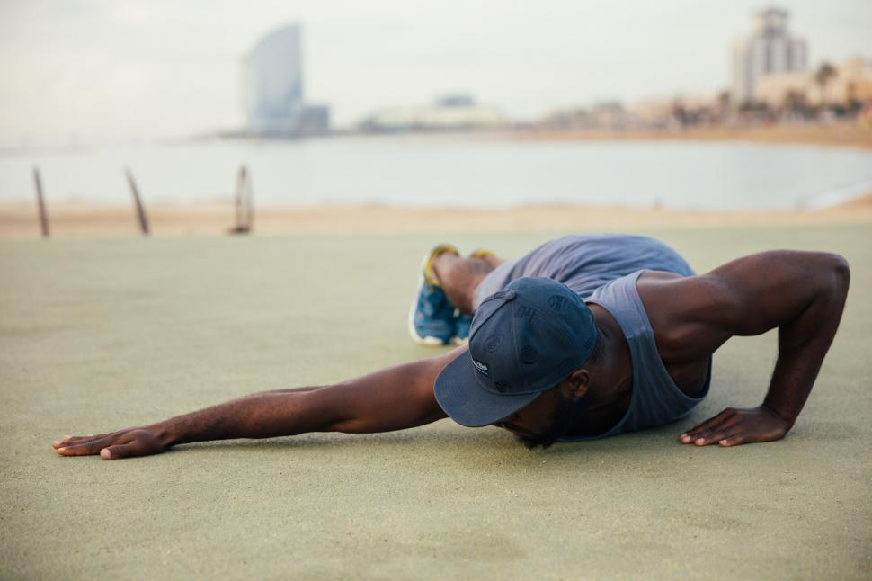 Free Image of A young African man stretching outdoors 