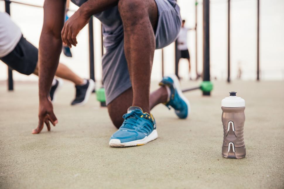 Free Image of A young African man doing kneeling-workout outdoors 