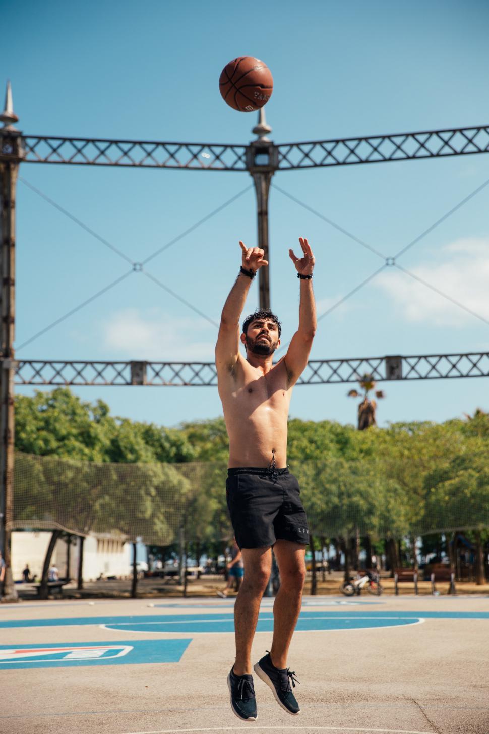 Free Image of A young man shooting a basketball 