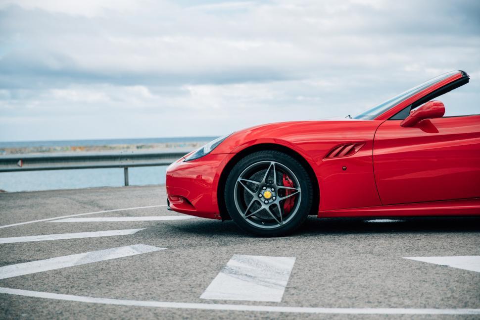 Free Image of Side view of a red convertible sports car 