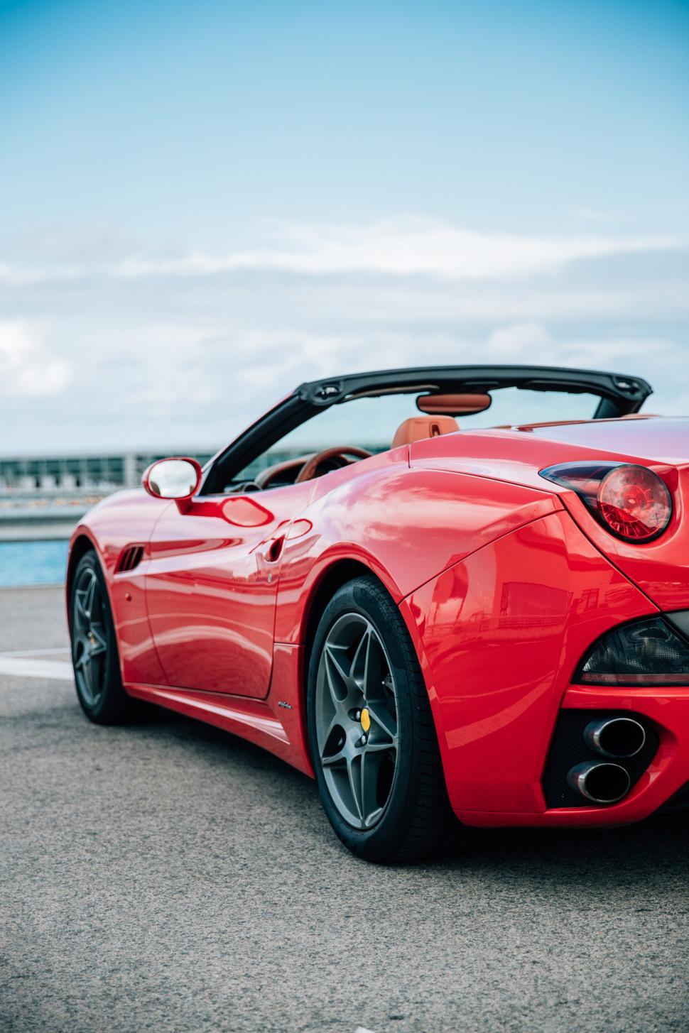 Free Image of Side view of a red convertible sports car 