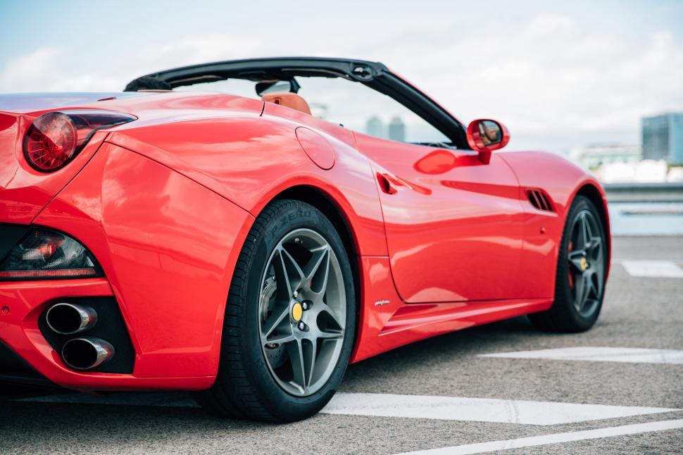 Free Image of Side view of a red convertible sports car 