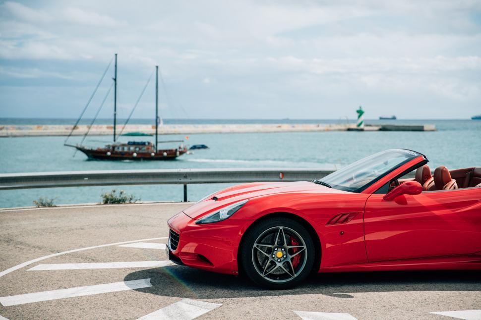 Free Image of Side view of a red convertible sports car 
