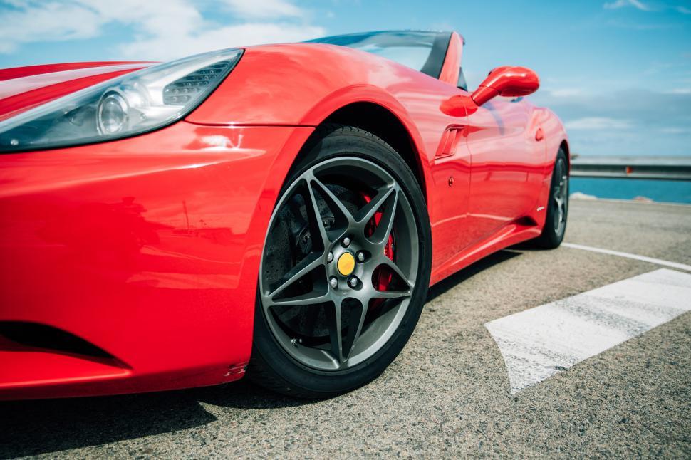Free Image of Side view of a red convertible sports car 