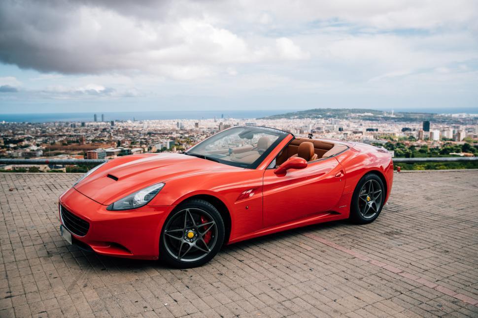 Free Image of Side view of a red convertible sports car 