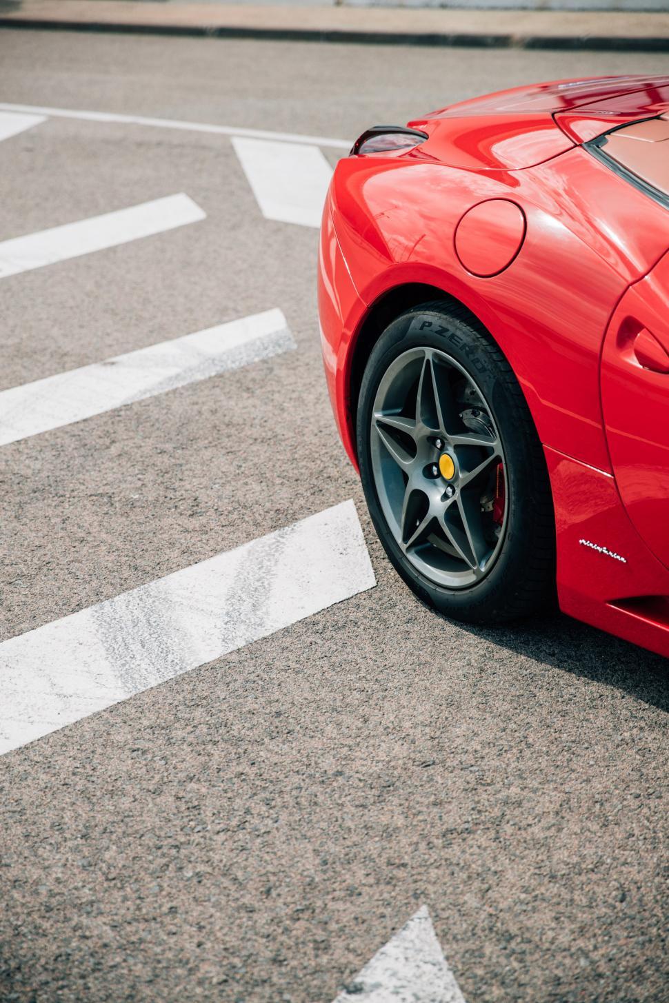 Free Image of Rear side view of a red convertible sports car 