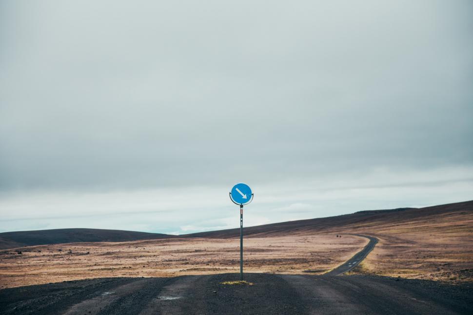 Free Image of Arrow road sign on a desert highway 