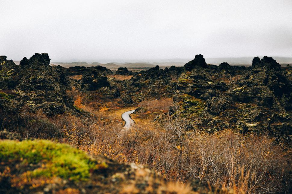 Free Image of A curvy road through the rocky terrain 