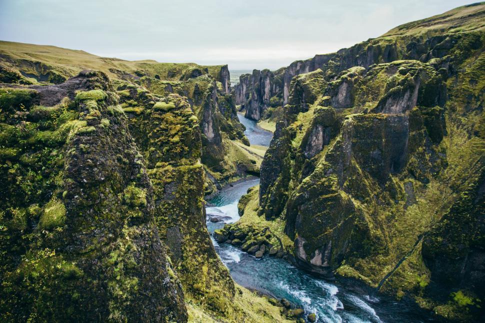 Free Image of Moss-grown mountain cliffs by glacial stream 