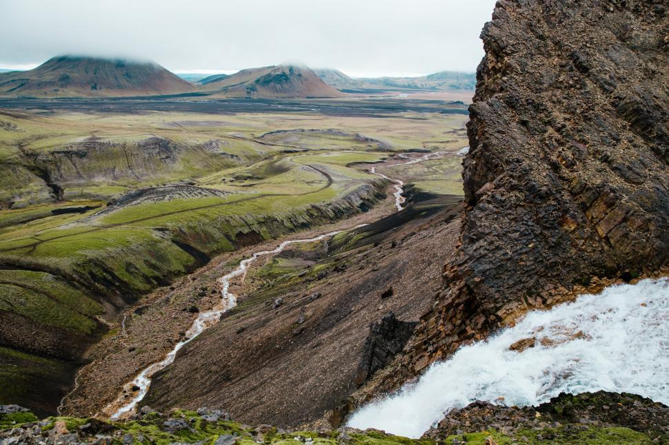 Free Image of Glacier water winding through rocky landscape 