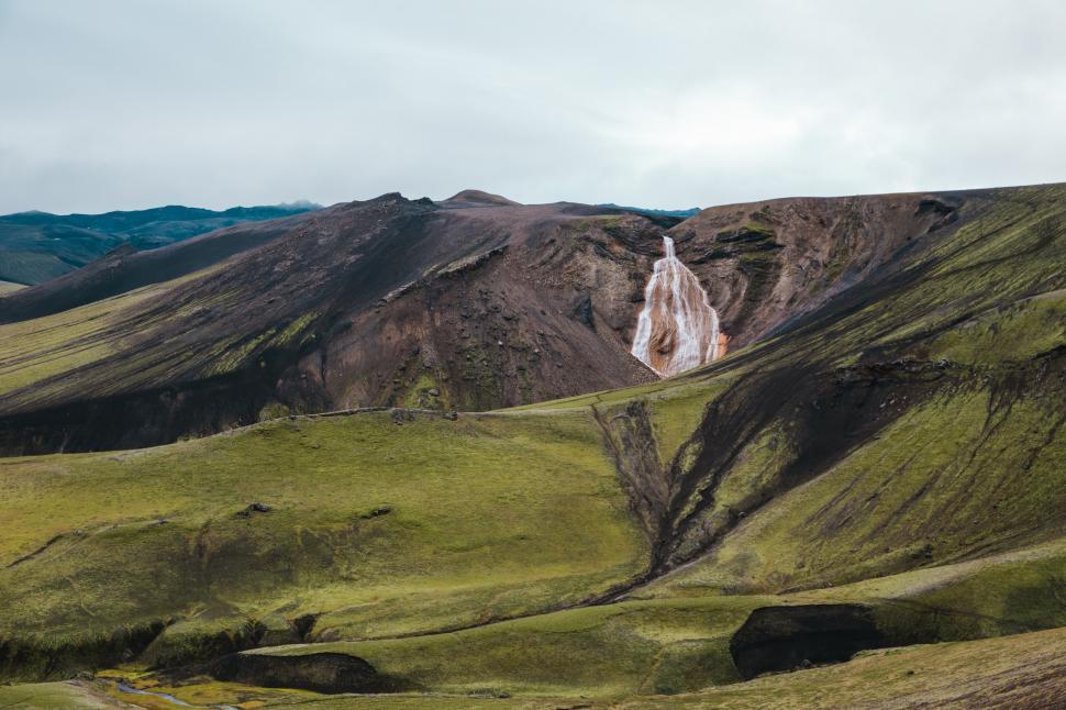 Free Image of A waterfall and green hills 