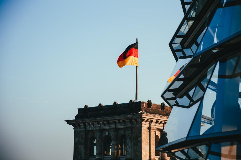 Free Image of German flag waves on a rooftop 