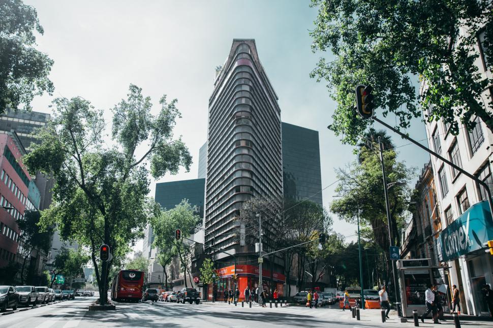 Free Image of Corner view of a glass building in a tropical city 