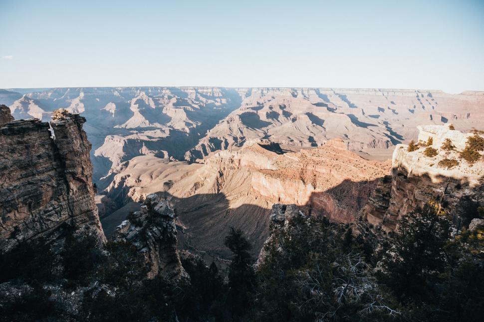 Free Image of Sun and shadows sprawling over grand canyons 