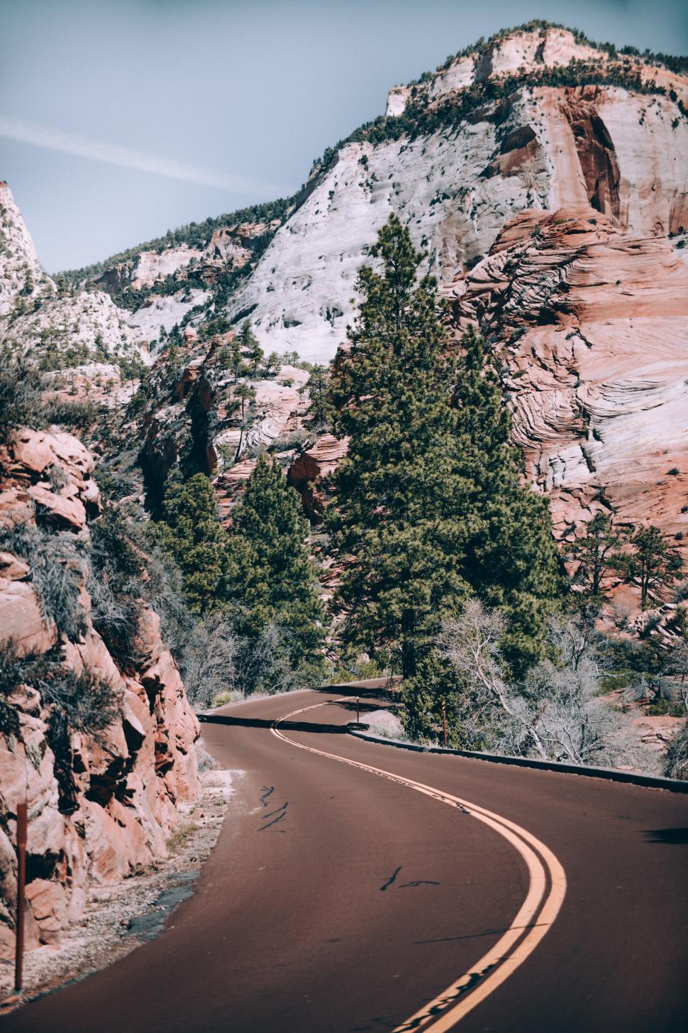 Free Image of A curvy canyon highway in the day time 