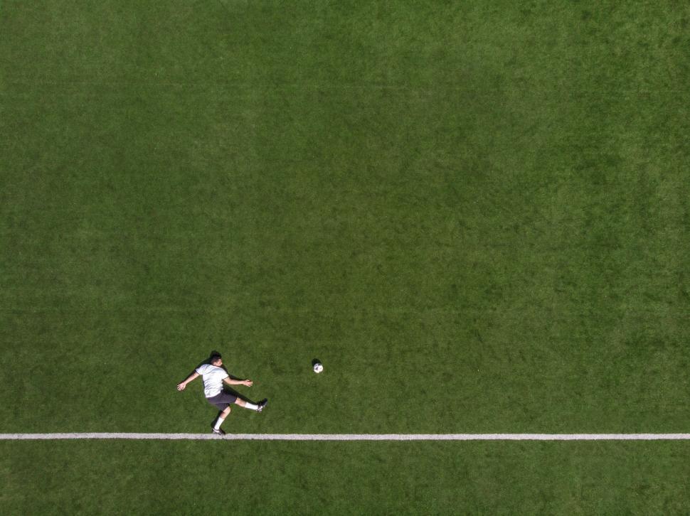 Free Image of Aerial view of a striker kicking the football 